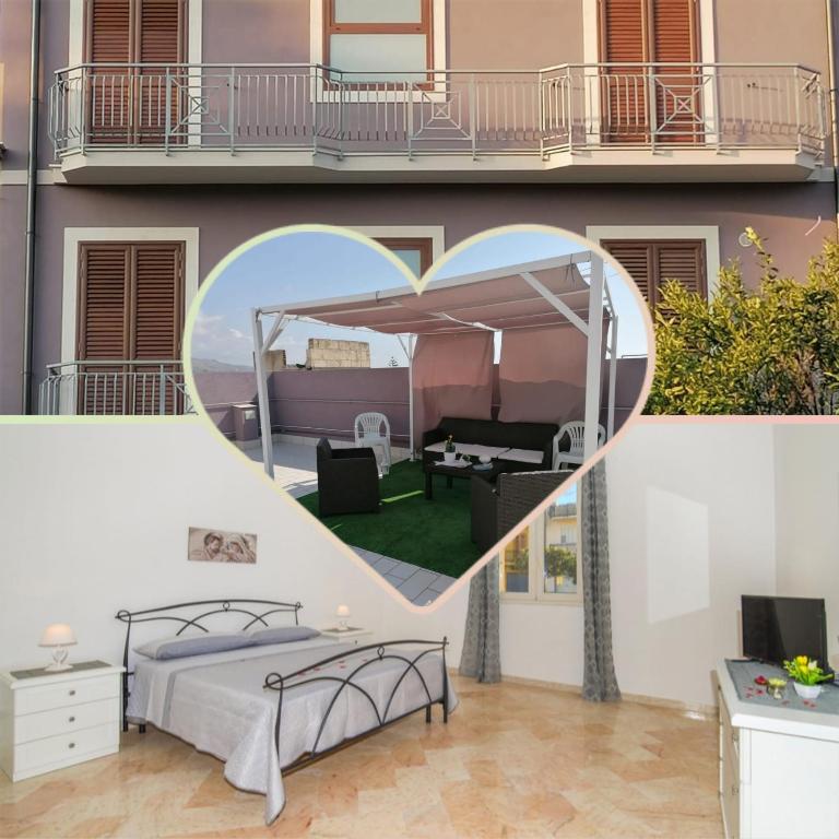 a bedroom with a bed in front of a building at Casa del Sole - Avola in Avola