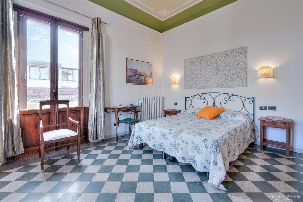 a bedroom with a bed and a large window at Soggiorno Isabella De' Medici in Florence