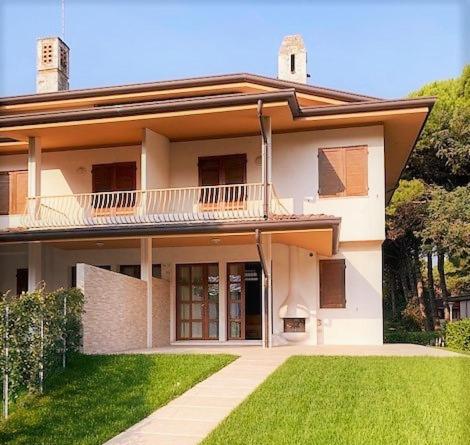 a large house with a lawn in front of it at Villa delle Terme in Lignano Sabbiadoro