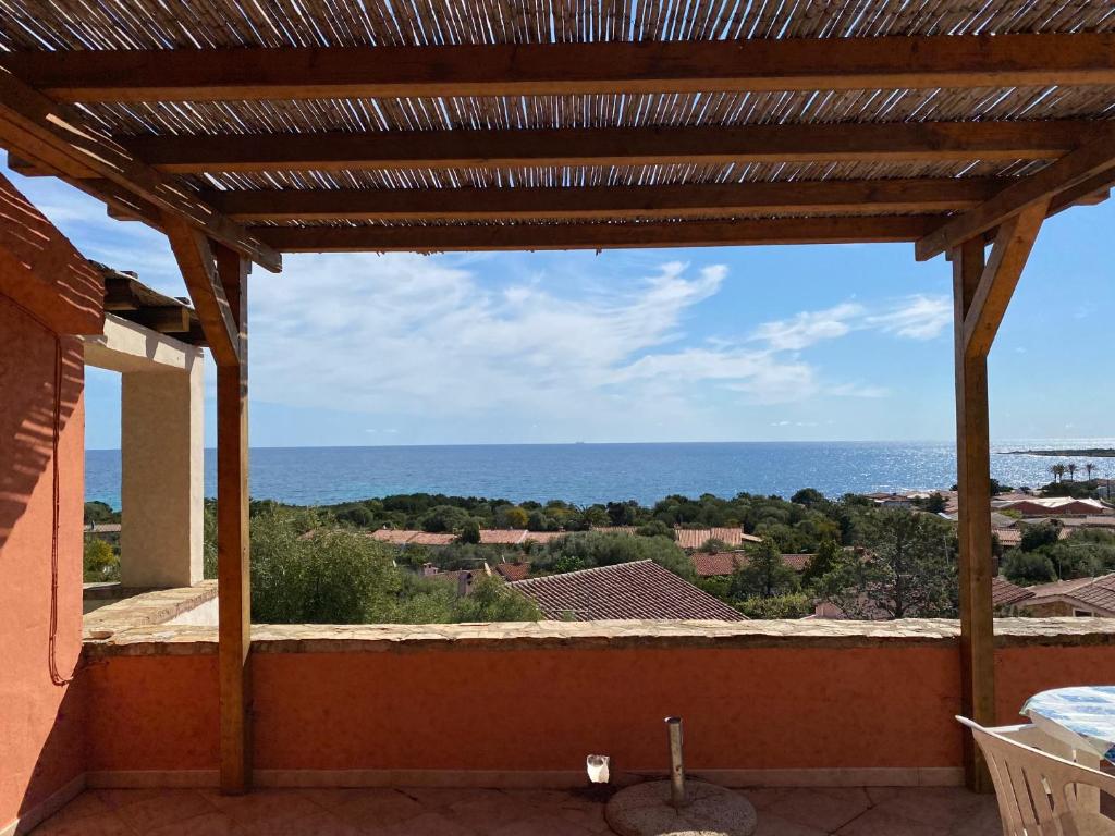 a view of the ocean from the balcony of a house at Appartamenti Cala d'Ambra in San Teodoro