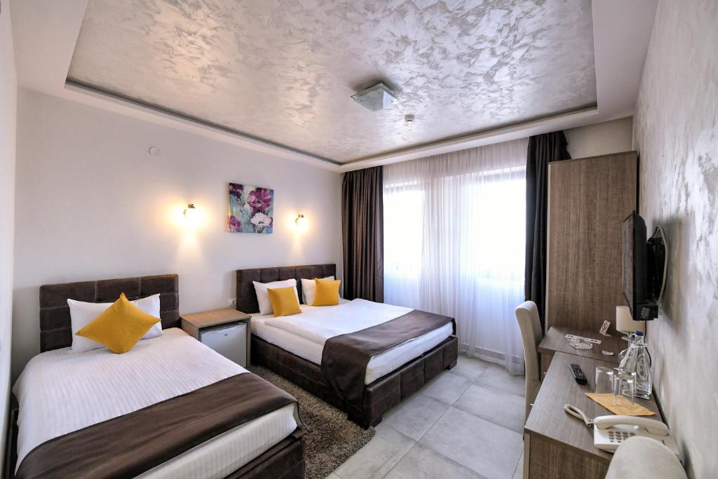 Postel nebo postele na pokoji v ubytování Garnet Hotel & Event Centar