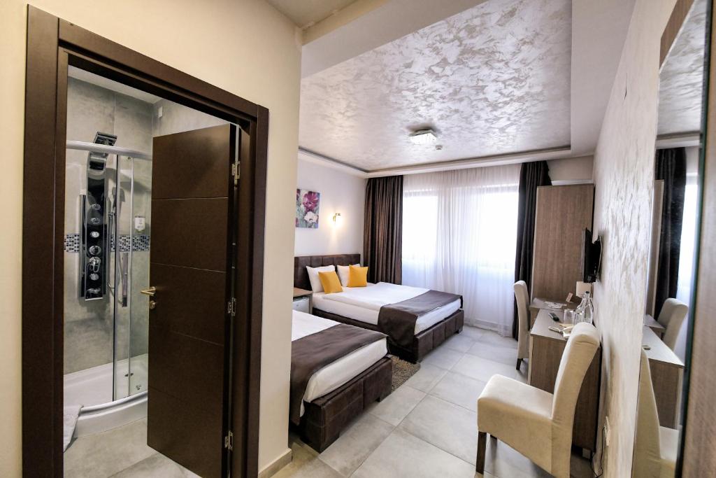 Postel nebo postele na pokoji v ubytování Garnet Hotel & Event Centar