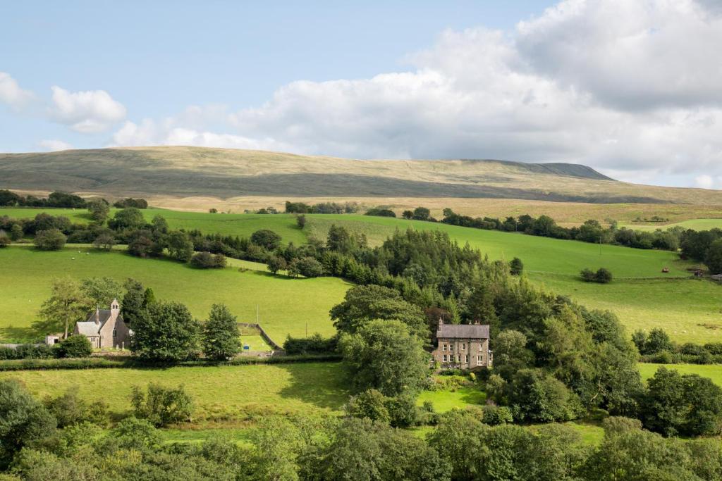 an aerial view of a house in a green field at St Marks Stays in Sedbergh