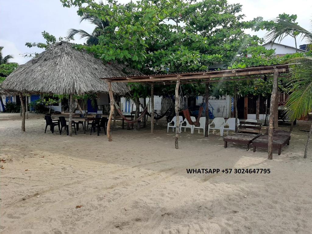 Rincón的住宿－Casa Madrigueña，海滩上带桌椅的餐厅