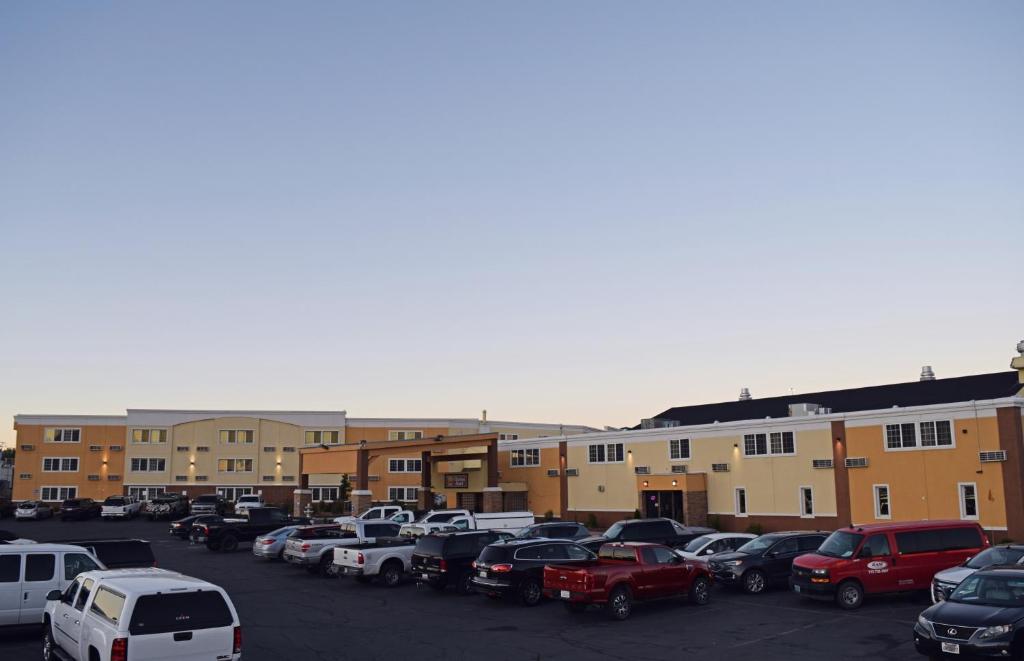 a parking lot with cars parked in front of buildings at Clarion Hotel Rock Springs-Green River in Rock Springs