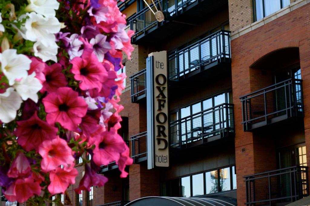 a building with pink and white flowers in front of it at Oxford Hotel Bend in Bend