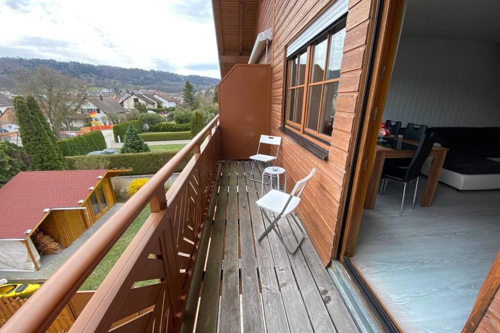 a balcony with two chairs and a table on a house at Brulaire Büsingen am Hochrhein in Busingen am Hochrhein