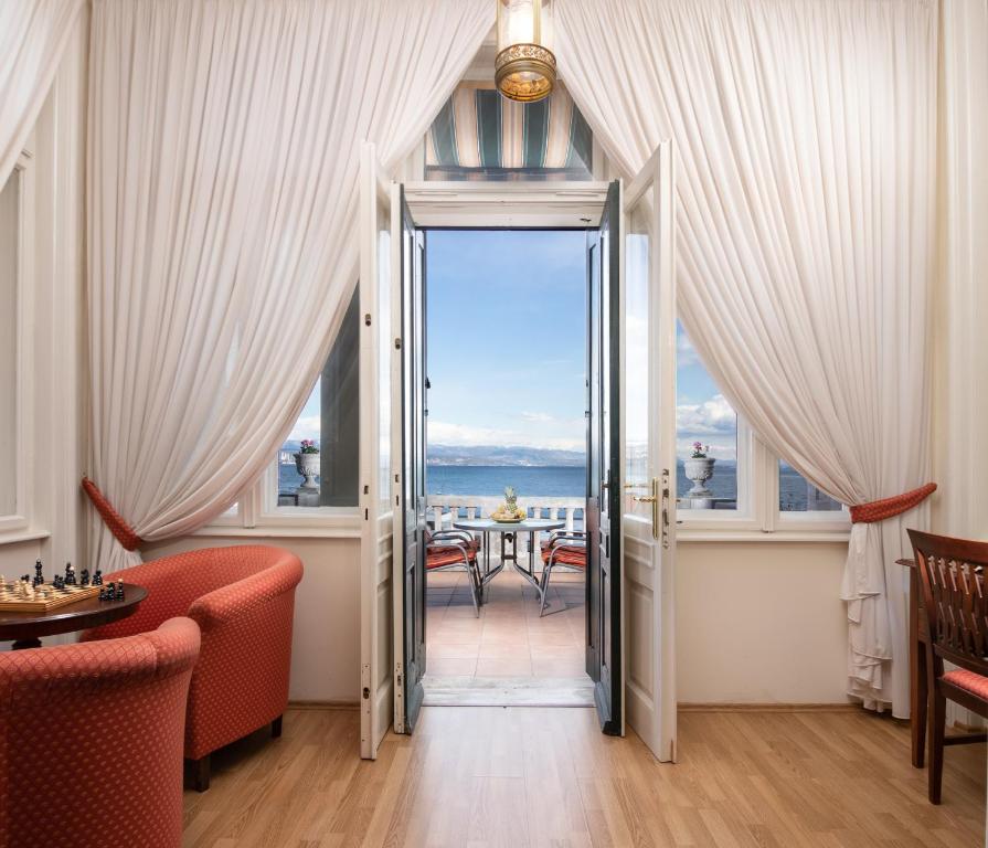 an open door to a dining room with a view of the ocean at Apartment Villa Regaly in Opatija