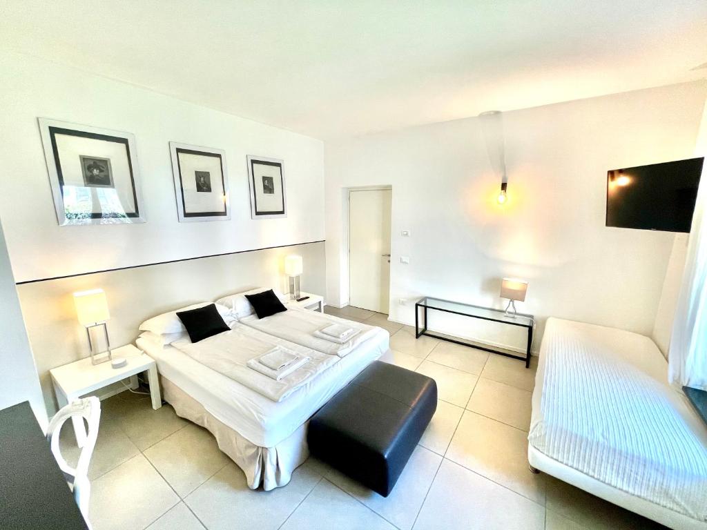a bedroom with a large bed and a couch at Carly's Rooms in Nago-Torbole
