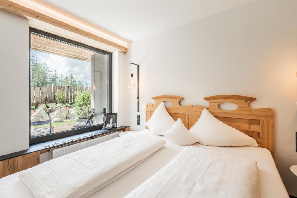 Posteľ alebo postele v izbe v ubytovaní s'Hoamatl Dorfkrug Appartements