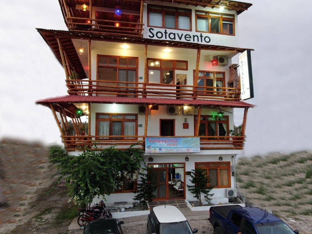 a building on top of a hill with motorcycles parked in front at Hotel Sotavento in Montañita
