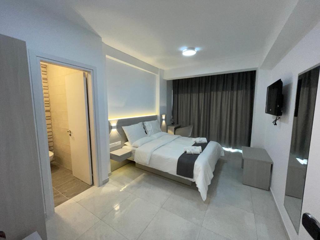 a hotel room with a bed and a bathroom at La Veranda Hotel in Larnaca