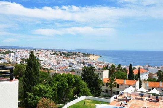 a view of a city with buildings and the ocean at Fabulous Sea view Studio near old town Albufeira in Albufeira