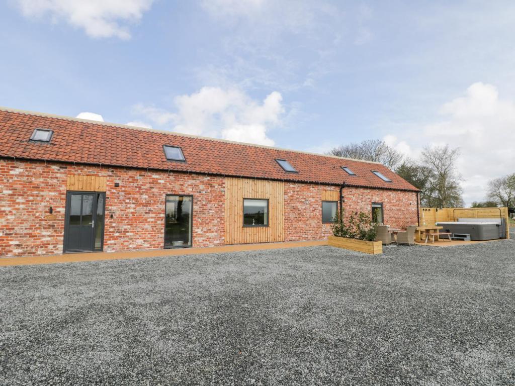 a brick building with solar panels on the roof at Pheasant's Roost in Hull