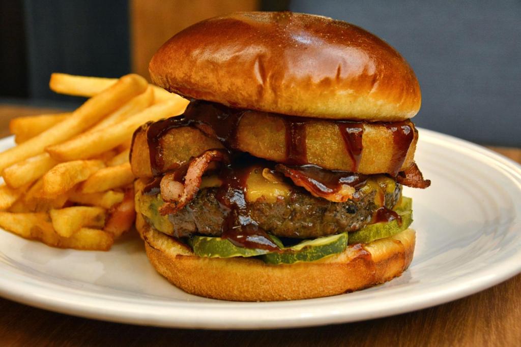 a cheeseburger and french fries on a white plate at Gold Country Casino Resort in Oroville