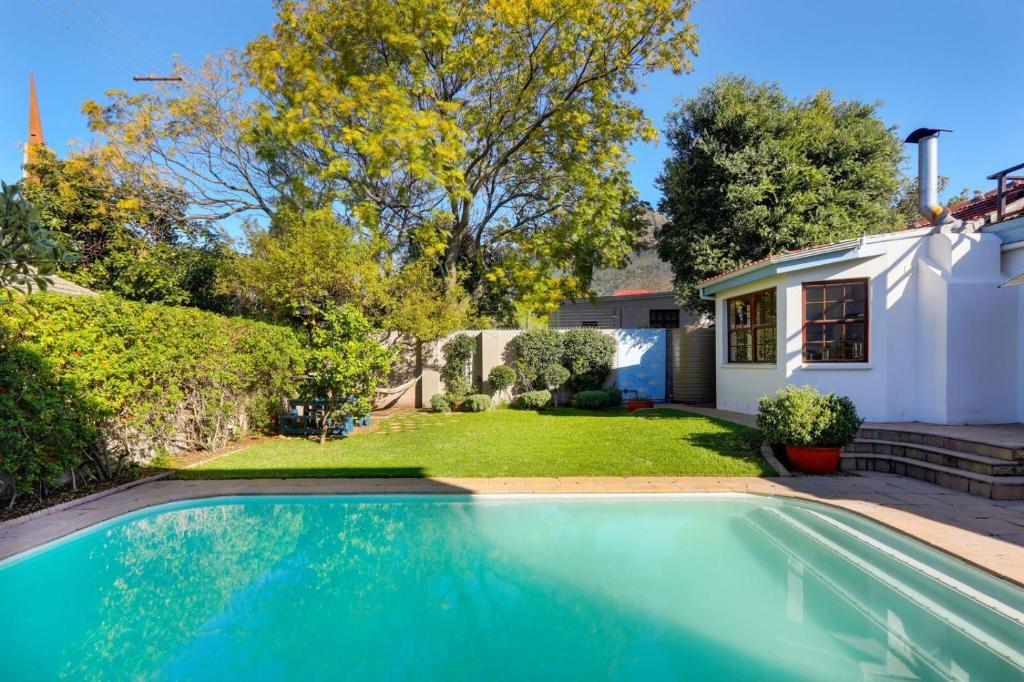 a swimming pool in front of a house at Villa Garda B&B in Cape Town