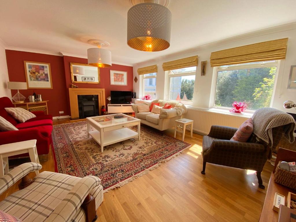a living room with a couch and a table at Braeside Luxury Holiday Home in Torquay