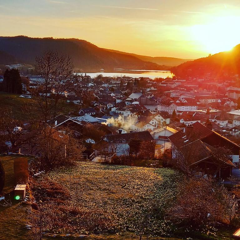 - une vue sur une ville au coucher du soleil dans l'établissement Aux Bonheurs du lac, à Gérardmer