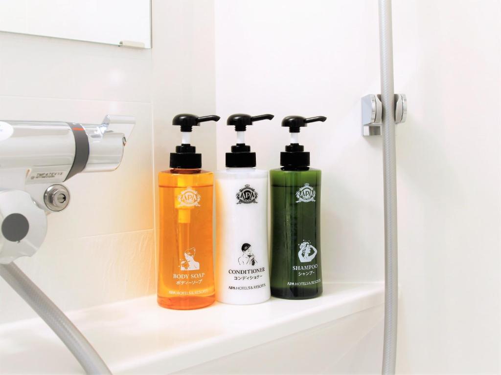 a bathroom shelf with two shampoo bottles on it at APA Hotel Nishifunabashi Ekimae in Funabashi