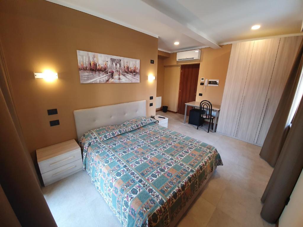a bedroom with a bed and a desk in it at azalea Rooms & apartments domo 3 5 in Baveno