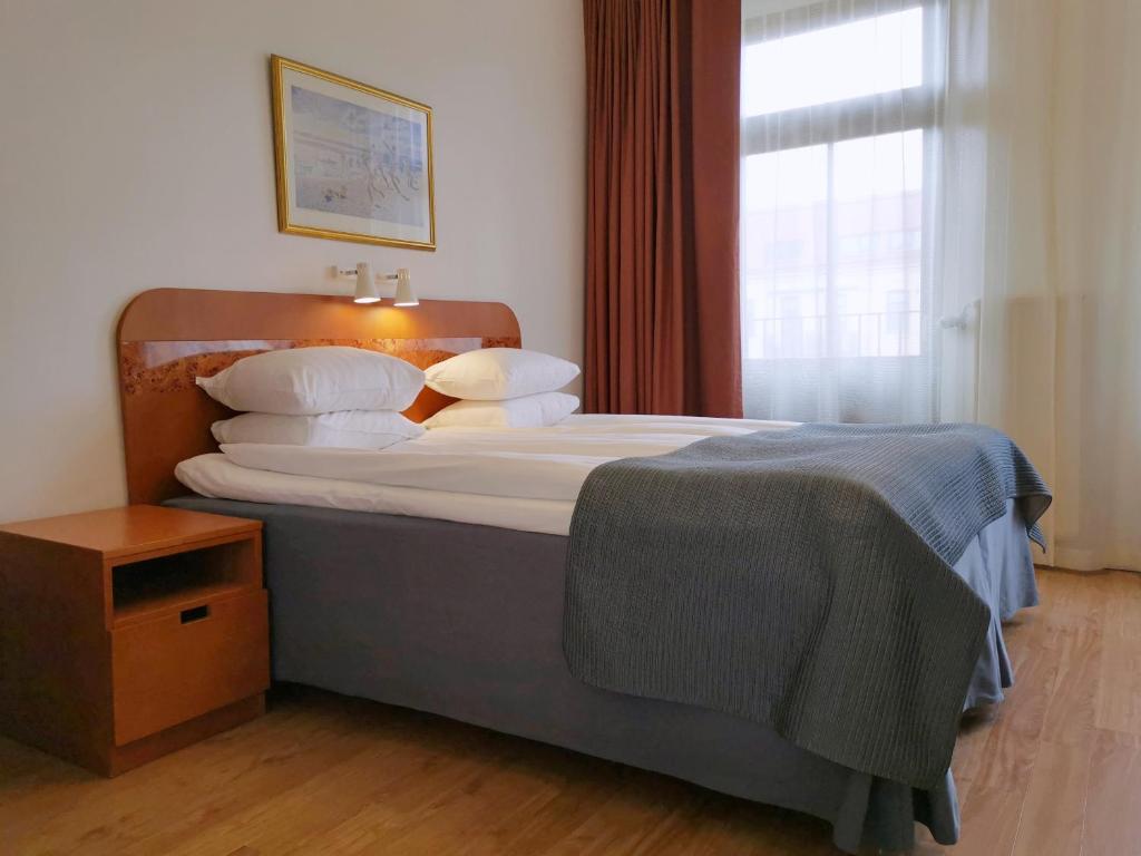 Postel nebo postele na pokoji v ubytování Hotel Lorensberg