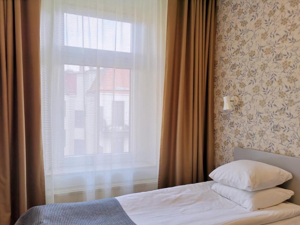 Säng eller sängar i ett rum på Hotel Lorensberg