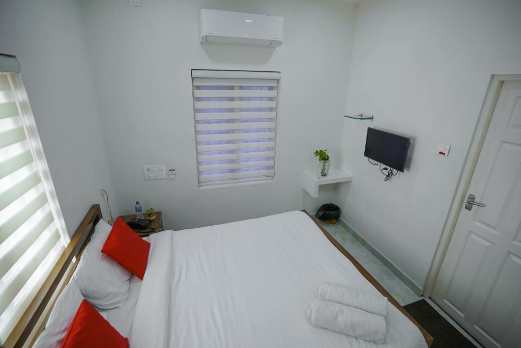 Postel nebo postele na pokoji v ubytování Adams Cottage Kochi