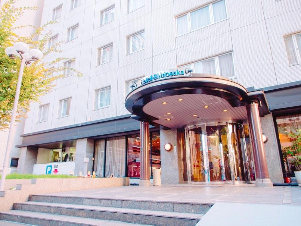 a store front of a building with stairs in front at Hotel Shin Osaka in Osaka