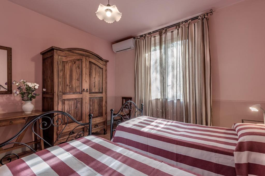 Postel nebo postele na pokoji v ubytování Villa Bellaria Lucignano