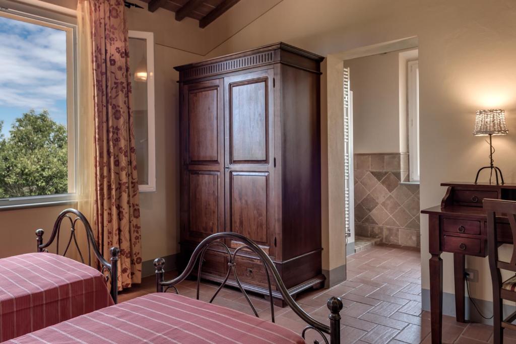 Postel nebo postele na pokoji v ubytování Villa Bellaria Lucignano