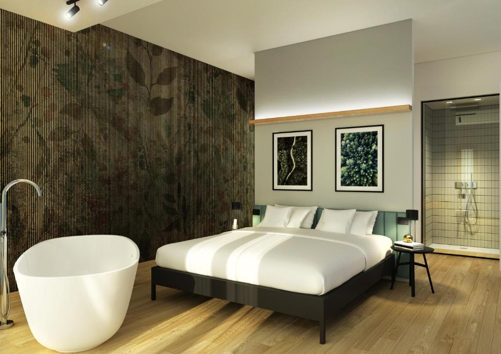 a bedroom with a large bed and a bath tub at Meg Lifestyle Hotel in Riccione