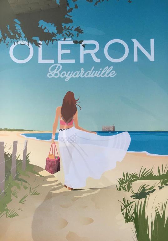 a woman in a white dress walking on the beach at Les Bains Boyardville - Hôtel et Restaurant in Boyard-Ville