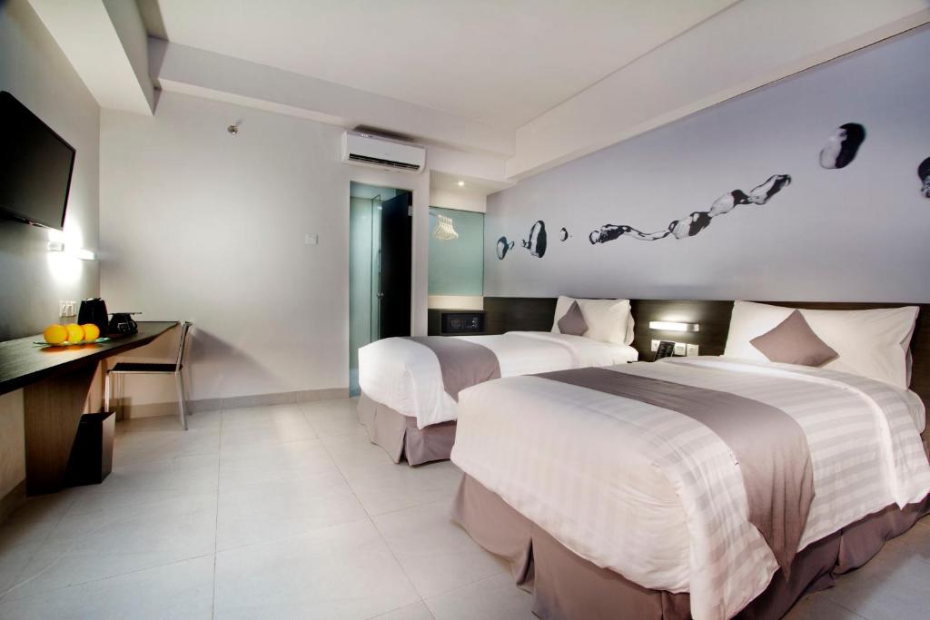 Postel nebo postele na pokoji v ubytování Neo Hotel Tendean Jakarta by ASTON