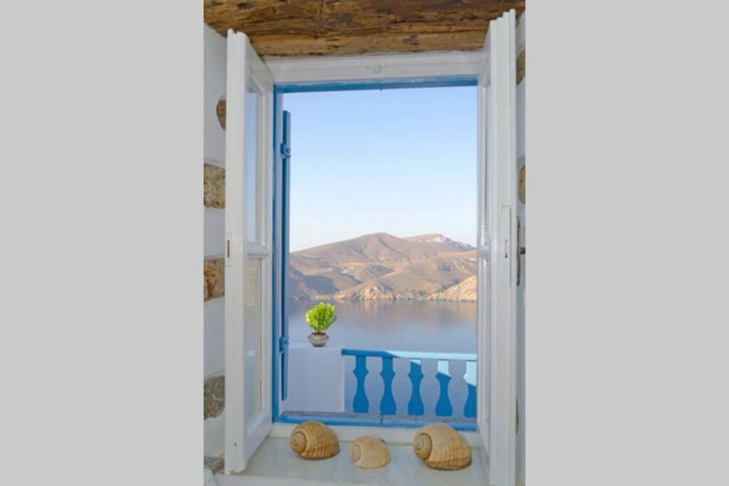 an open window with a view of the sea at Nikola's Place in Astypalaia Town