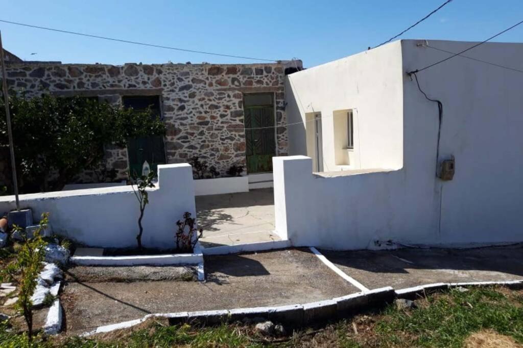 een wit huis met een deur en een gebouw bij Orange garden in Karídhion