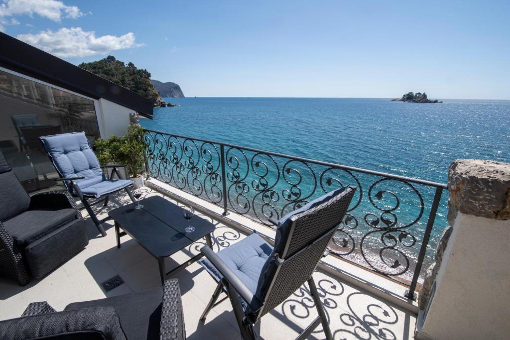 a balcony with chairs and a view of the ocean at SYMPHONY in Petrovac na Moru