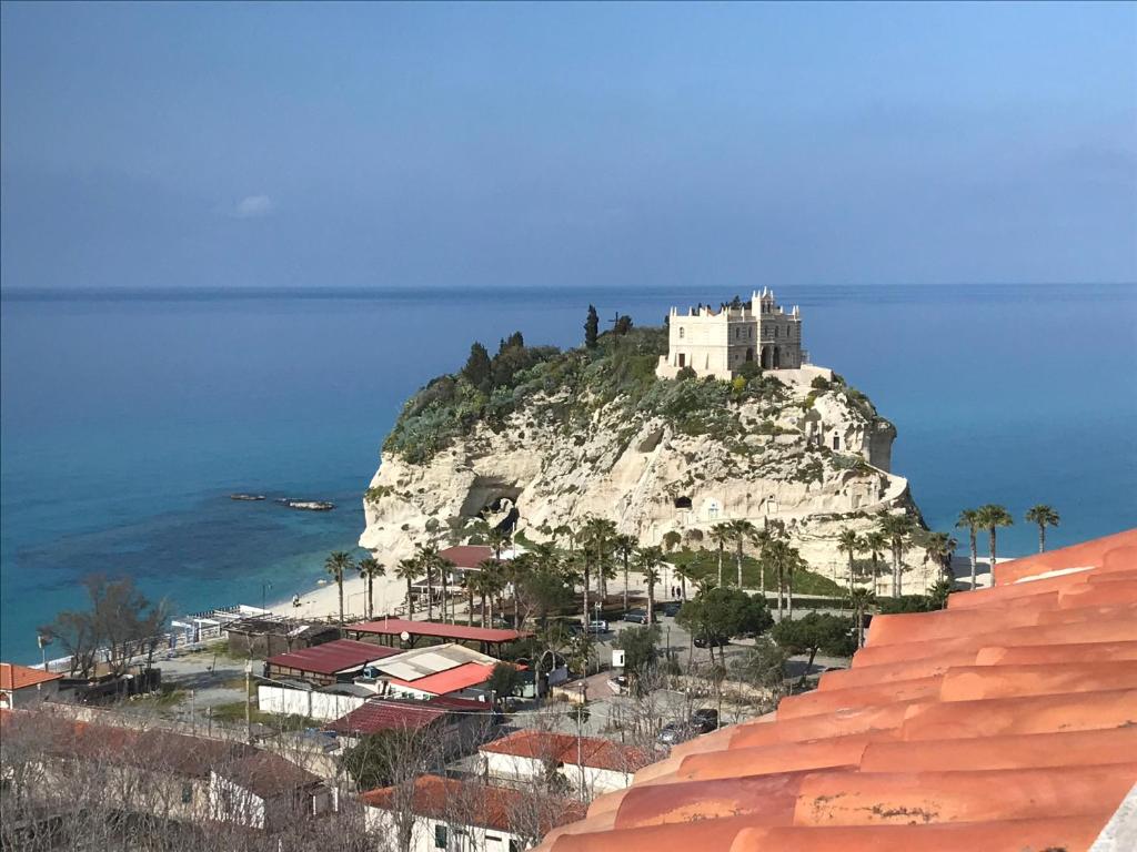 a castle on top of a mountain with the ocean at Nereide in Tropea