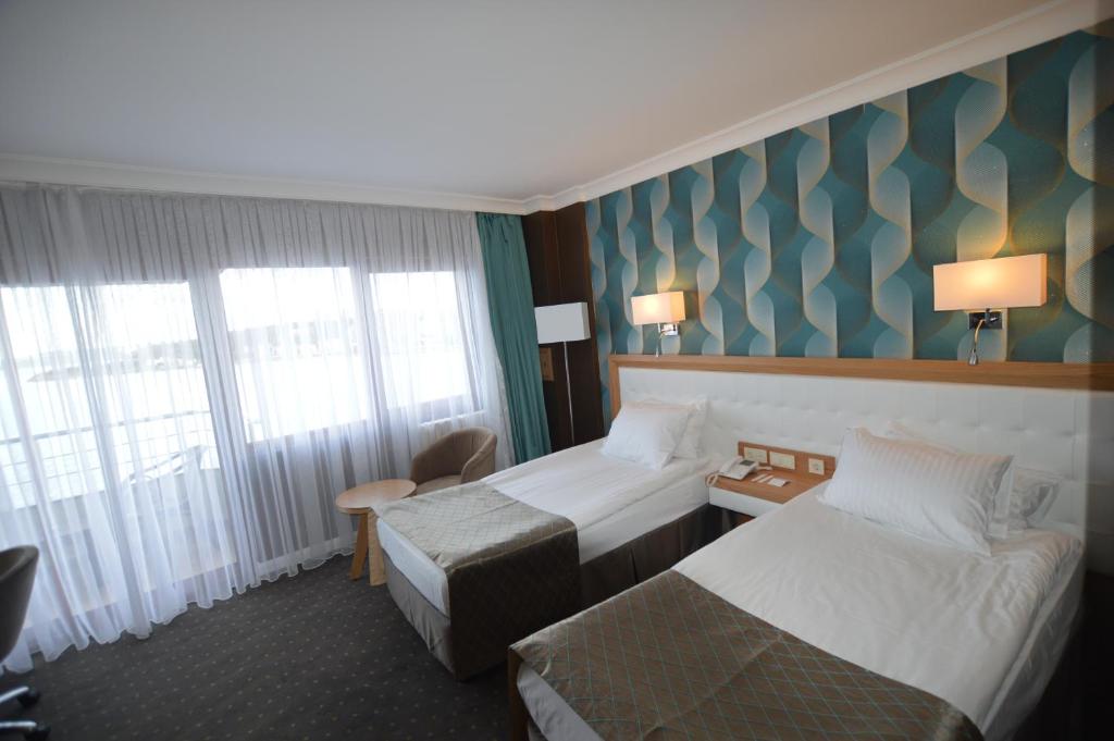Postel nebo postele na pokoji v ubytování Akol Hotel