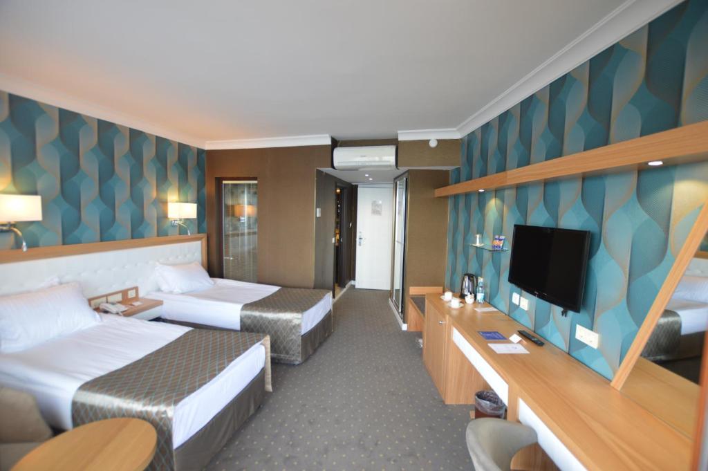 Postel nebo postele na pokoji v ubytování Akol Hotel
