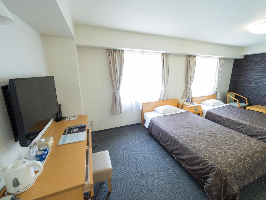 Postel nebo postele na pokoji v ubytování Hotel Shin Osaka