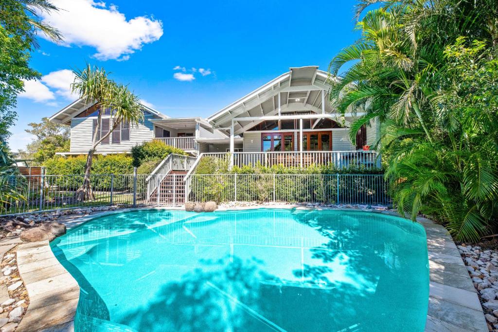 a house with a swimming pool in front of a house at Serenity - Mudjimba - Pet Friendly Holiday Home in Mudjimba