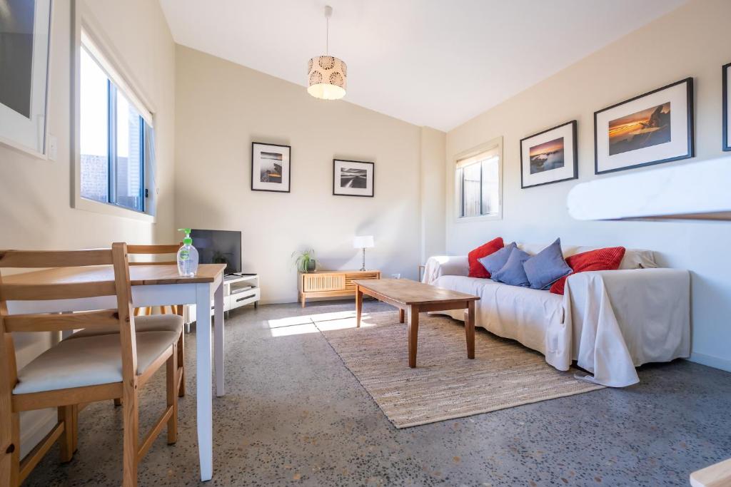 a living room with a couch and a table at Hazards Escape - the Top Shack & the Short Stack in Coles Bay