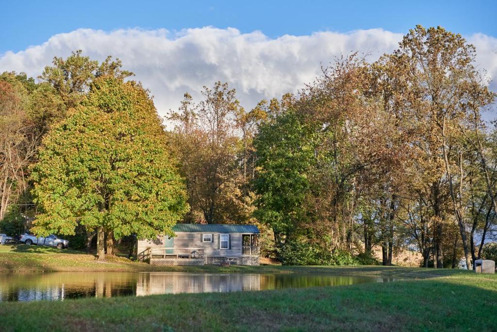 a small house in the middle of a lake at Spring Gulch Lakefront Park Model 5 in Mount Airy