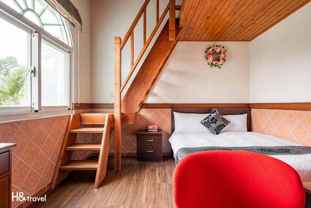 a small bedroom with a bed and a staircase at Shan Tyi Homestay in Ji&#39;an