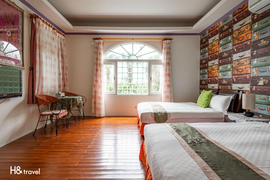 a room with two beds and a table and a window at Shan Tyi Homestay in Jian