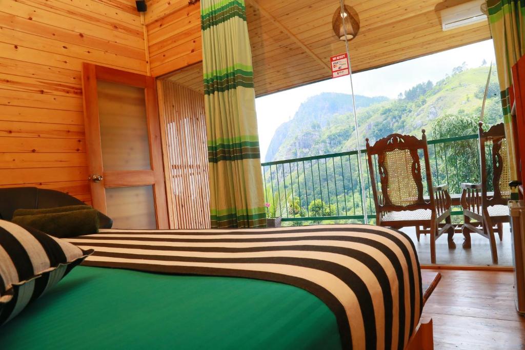 a bedroom with a bed and a balcony with a view at Ella Country House in Ella