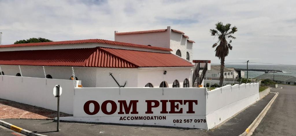 
a sign on the side of a building at Oom Piet Accommodation in Gansbaai
