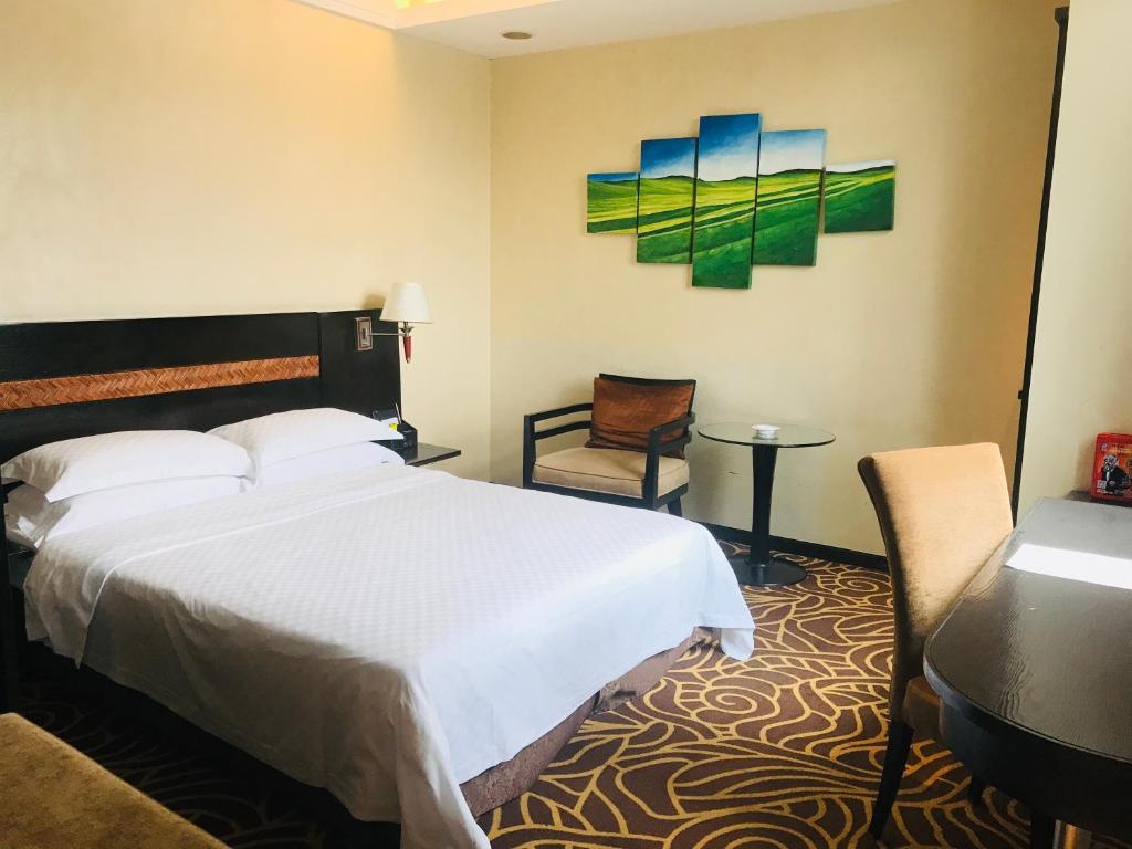 Postel nebo postele na pokoji v ubytování Hua Shi Hotel