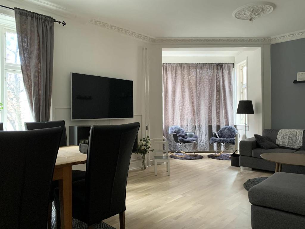 a living room with a table and a tv at ApartmentInCopenhagen Apartment 720 in Copenhagen