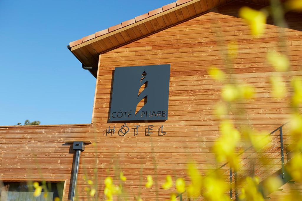 a building with a sign on the side of it at HOTEL COTE PHARE in Contis-les-Bains